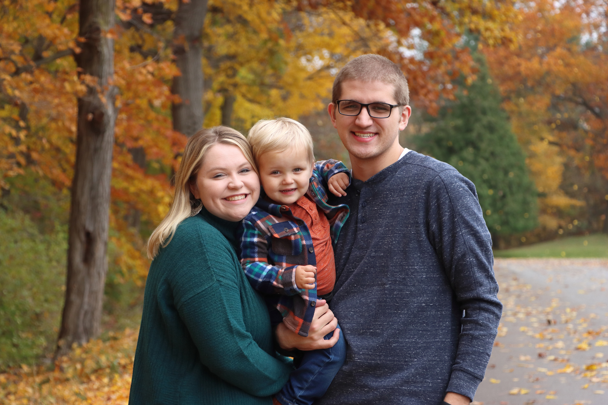 mom, dad and their son at Fitzgerald Park in Grand Ledge on a crisp fall day.