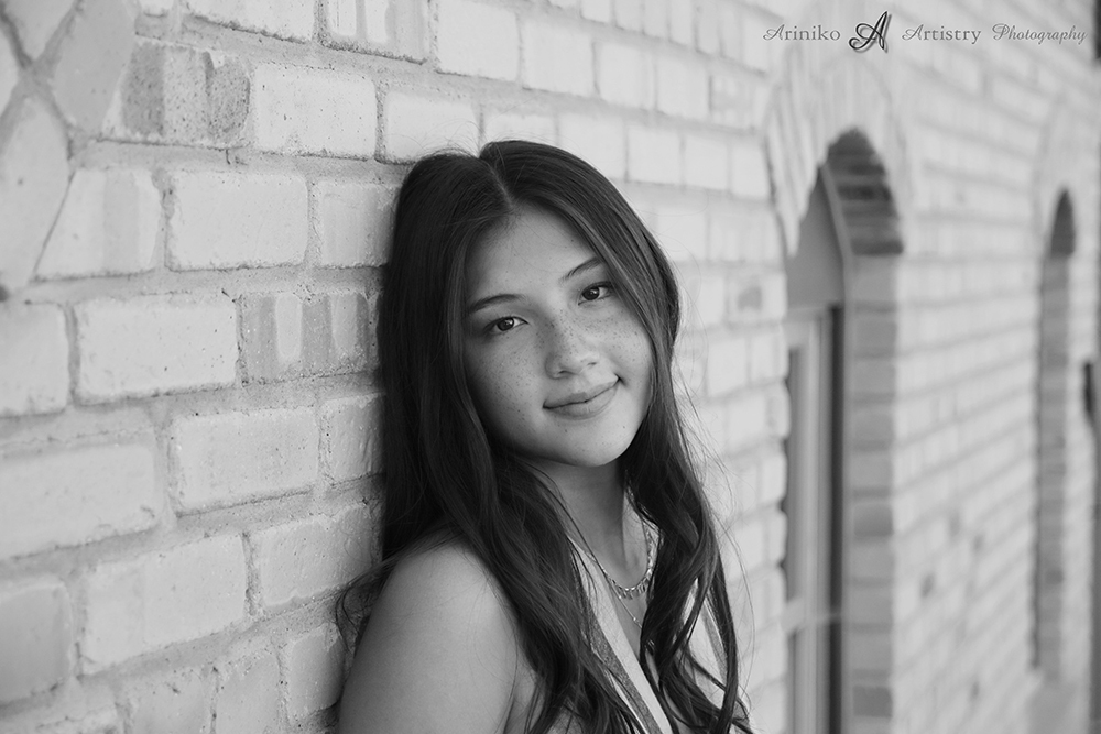 Young woman posing in Old Town Lansing, Michigan, image has been converted to black and white