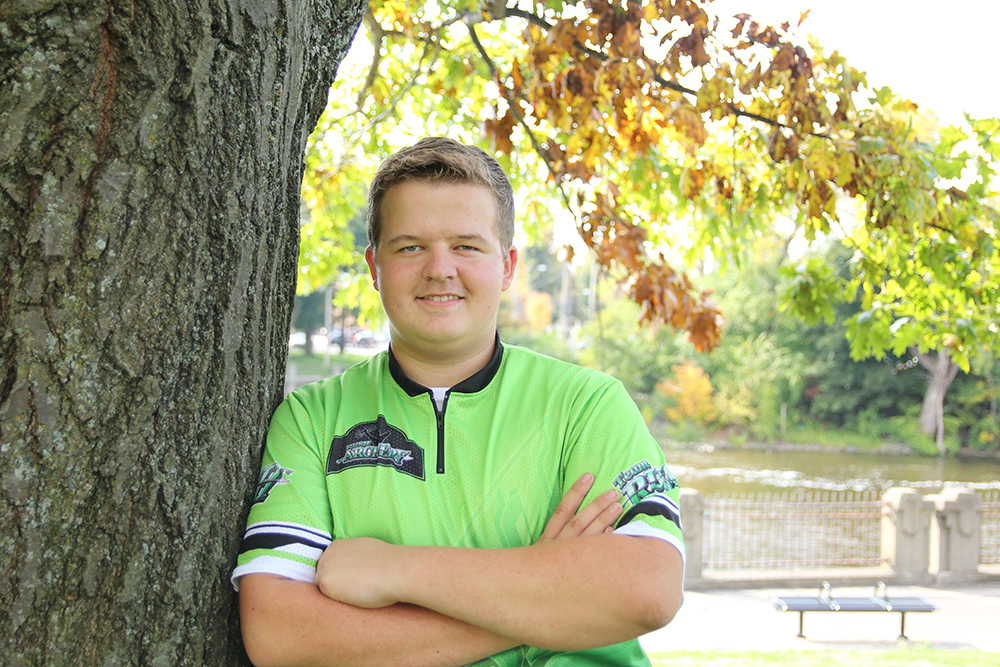 Young man posing near Brenke Fish Ladder in Lansing, Michigan