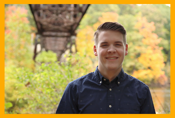 young man posing posing for senior portrait at Fitzgerald Park in Grand Ledge, Michigan