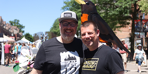 Andrew Sanstedt and Paul Schmidt pose in front of Andrew's welded hard or a robin in a nest. 