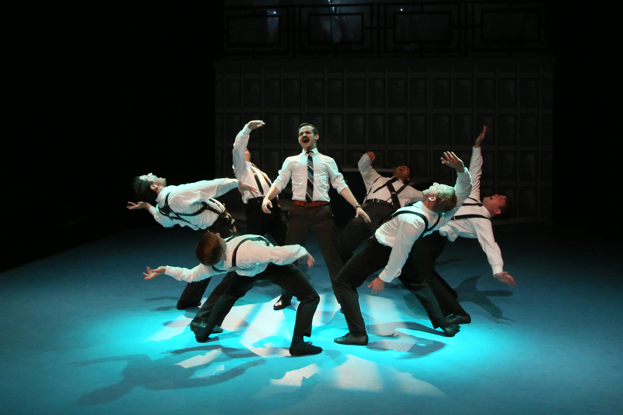 Men in office attire dancing.