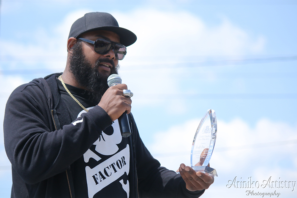 TJ Duckett receiving an award for his charity work