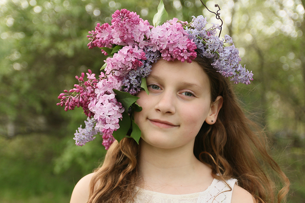 Young girl with lilac flower crown in her hair
