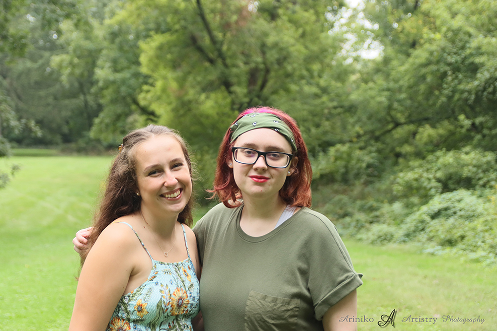 two Charlotte High School Seniors posing together outside at Bennett Park