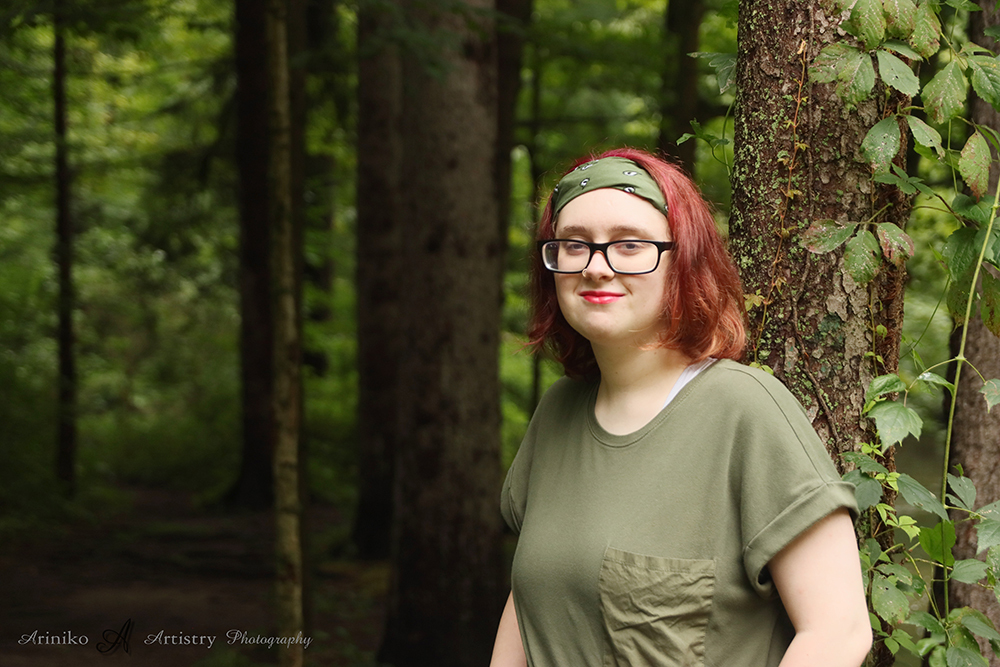 young person posing near the river in Charlotte, Michigan