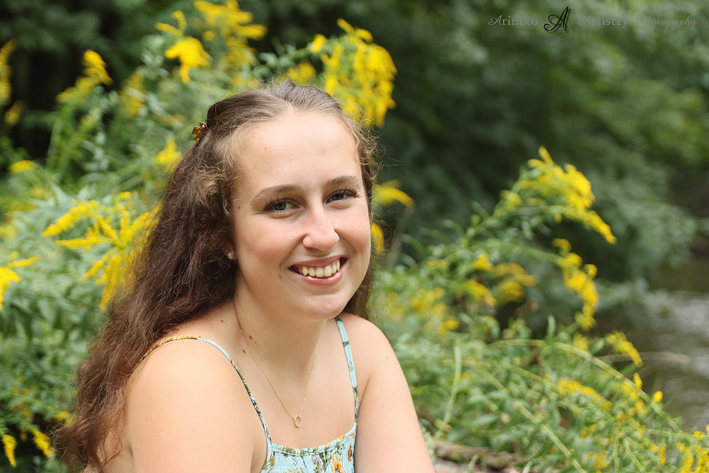 young woman posing on the banks of the river in Charlotte, Michigan