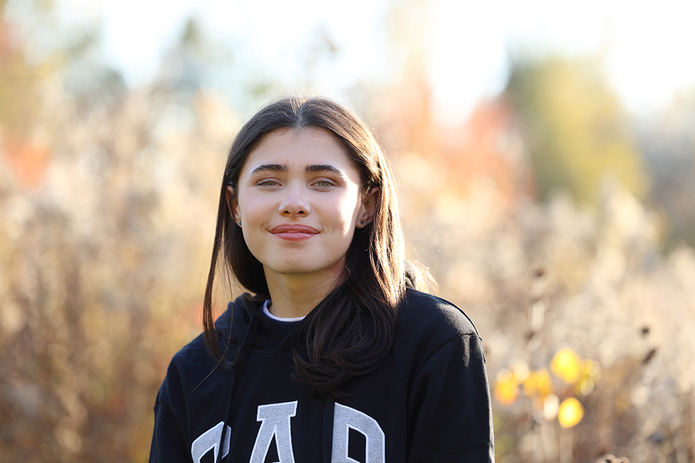 Young woman posing in a field at Meridian Historical Village
