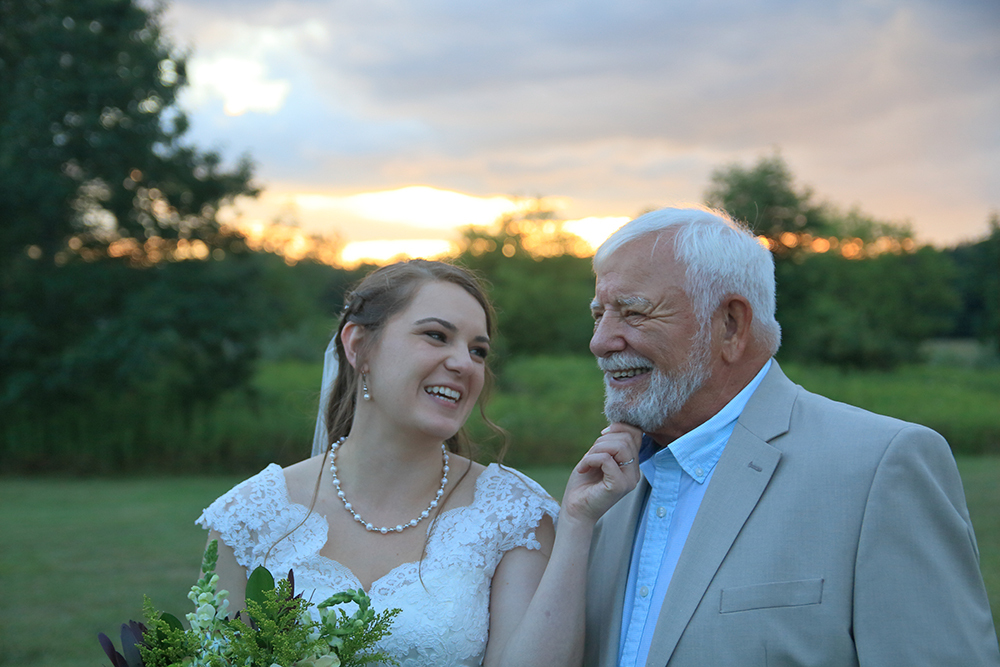 beautiful bride with her grandpa after the wedding